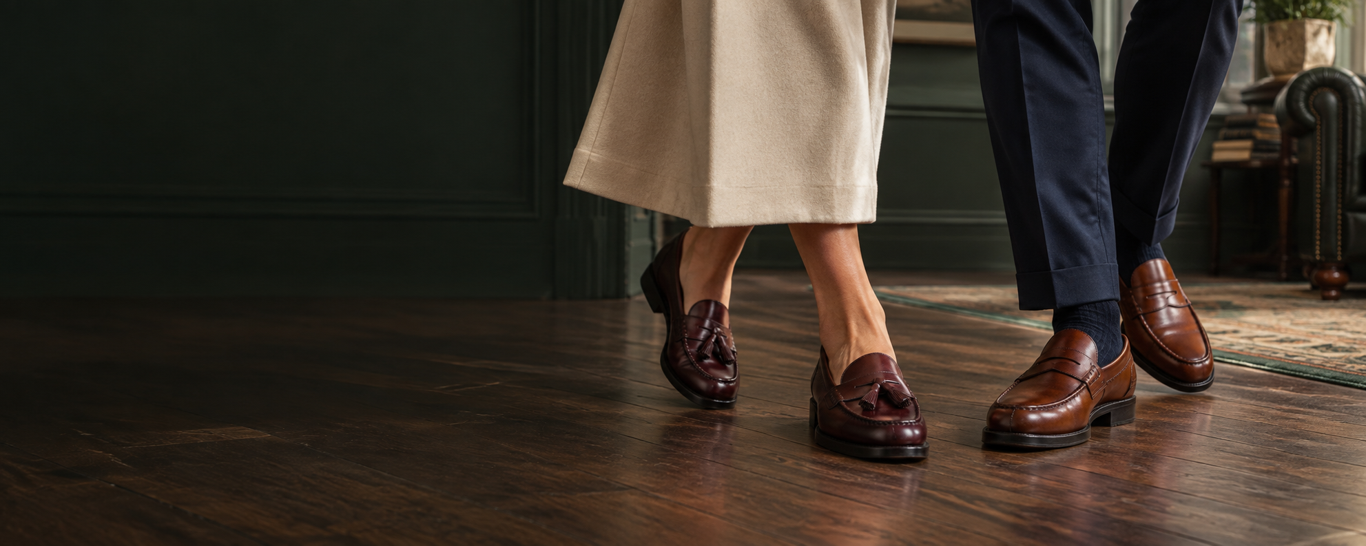 Saxone loafers for women and men, worn on a wooden floor